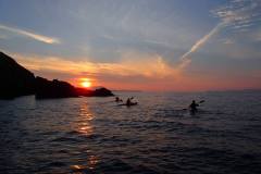 Sea kayaking at sunset In Ireland